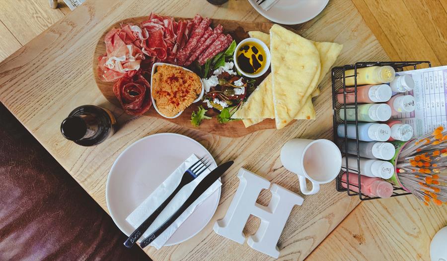 Mixed meat platter with drinks and blank ceramic items