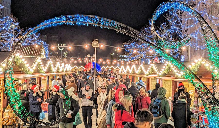Plymouth Christmas Market, with the colourful illuminated wave at the entrance