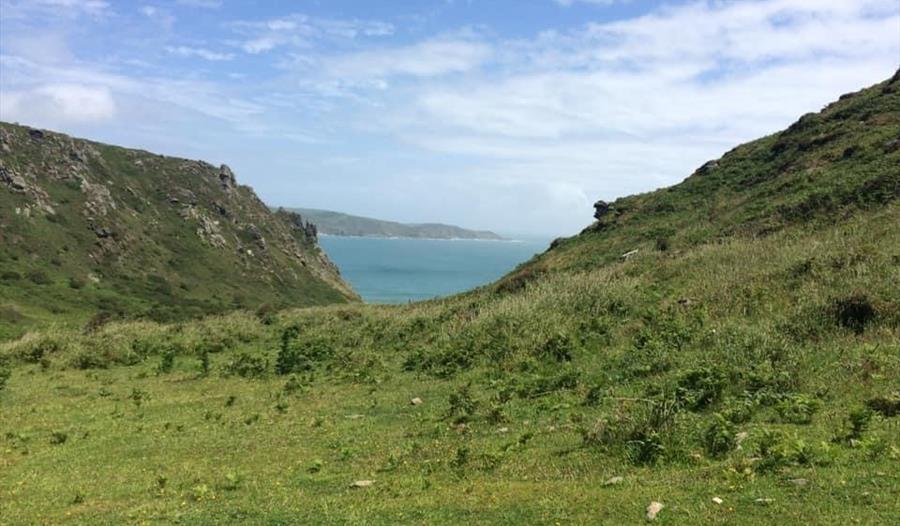 View through shallow valley to sea beyond