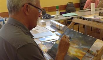 Artist Bryan Hill working on a painting for the exhibition