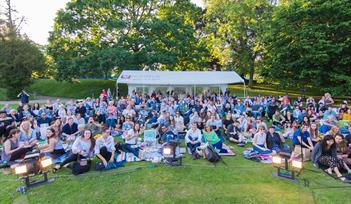 Theatre goers enjoy the outdoor spectacle of Private Lives by Noel Coward at Devonport Park, Plymouth