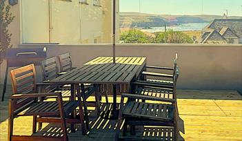 This image shows the south-facing terrace at Little Byfield in Thurlestone, South Devon.  There are stunning sea views. It is sheltered from the wind