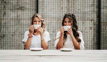Two women drinking coffee