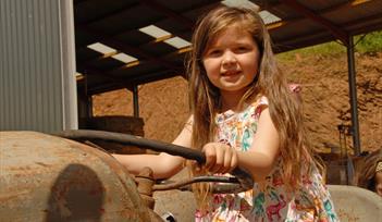 Photo of girl on an old tractor