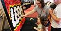 LEGO Display, Family Surrounding a LEGO pit building, a child sat infront of the graffiti wall creating in LEGO, A Stall Selling LEGO