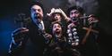 Dracula: The Bloody Truth by Le Navet Bete. Four performers stare at the camera holding garlic, crucifixes and a stake, all looking terrified.