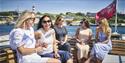 4 ladies on the open top deck of a boat