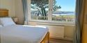 Master Bedroom with sea views. This has a king-size bed and ensuite shower room/toilet. Its facilities include a wardrobe, chest of drawers, bedside t