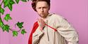 Cheeky prince blowing a kiss towards the camera with a pink background