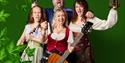 Four people with tankards cheering with green background