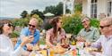 a social gathering of people enjoying food and drink from East Devon