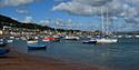 Teignmouth River Beach with boats all along it