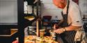 Head chef preparing fresh food in The Kitchen.