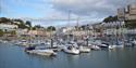 Boat lined up in Torquay Harbour with view of harbourside behind