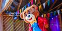 An image of a mascot - a bear on a Piazza Stage