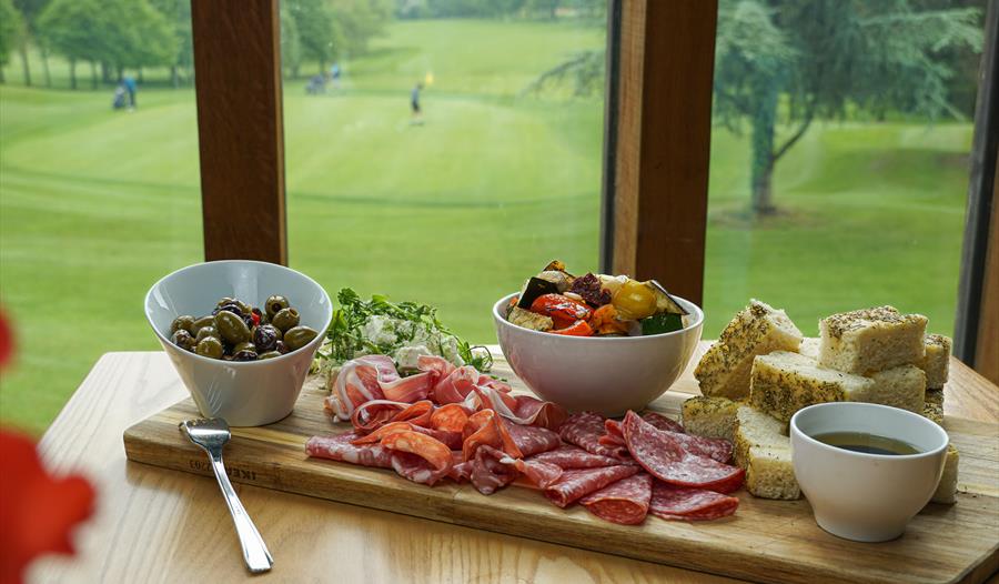 Charcuterie board with olives and salami Charcuterie board with olives and salami