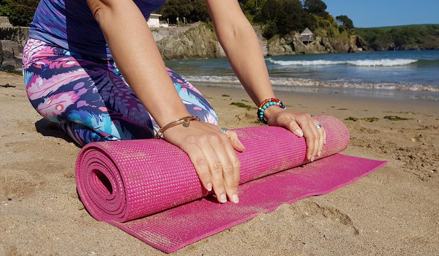 Yoga Mat being unrolled on Hope Cove Beach, near Kingsbridge