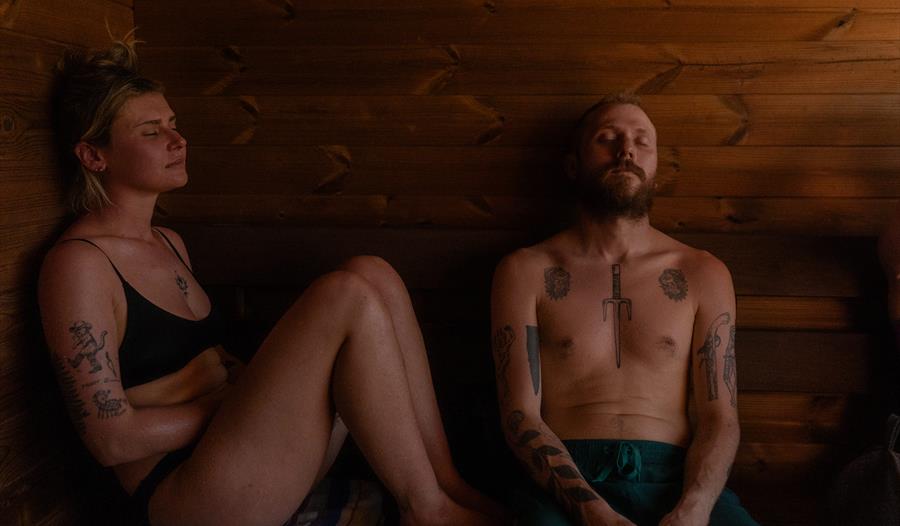 Two people serenely sweating in the sauna Two people serenely sweating in the sauna