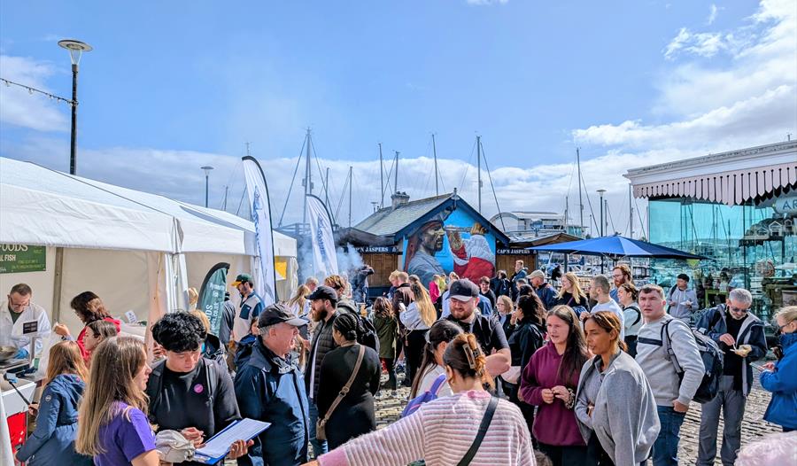 crowds enjoys the delicious food stalls and chef demonstrations at Seafest Plymouth crowds enjoys the delicious food stalls and chef demonstrations at Seafest Plymouth