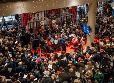 Howden Christmas Racing Weekend at Ascot | people carol singing with Ascot Brass Band