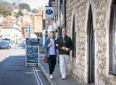 Couple walking along Hythe High Street in Kent