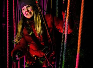 Lady having fun at Go Ape Black Park after dark - an adult only event