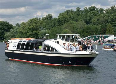 boat on the river with people watching Henley Regatta