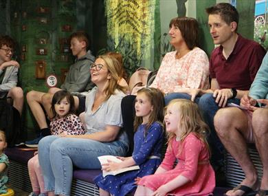 Children laughing and enjoying a storytelling session