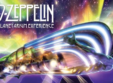 Led Zeppelin album cover. There is a metallic man in the centre of the image with a mountainous background and aurora in the night sky. 