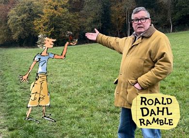 A man gestures towards a Quentin Blake illustration of Billy and the Minpins