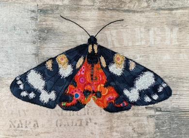 Picture of a butterfly made from textiles as part of exhibition at Sir Harold Hillier Gardens