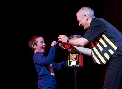 A magician showing a child a ball