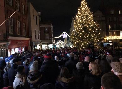 Carols on the Hill - crowd singing around the Christmas tree and with military band, Christmas lights in background