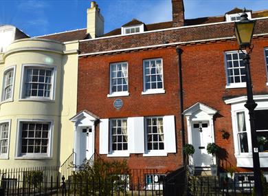 Photograph showing the exterior of the Charles Dickens' Birthplace Museum under a blue sky