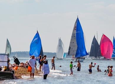 People swimming in the sea watching the boats sailing, Cowes Week, event, what's on