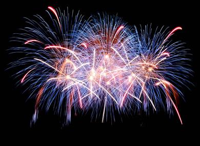 Stock photograph of fireworks going off against a black night sky