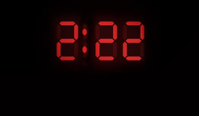 The numbers 2.22 are displayed in a large red font, like that of a digital clock display. In smaller capital white letters underneath reads: 'A Ghost