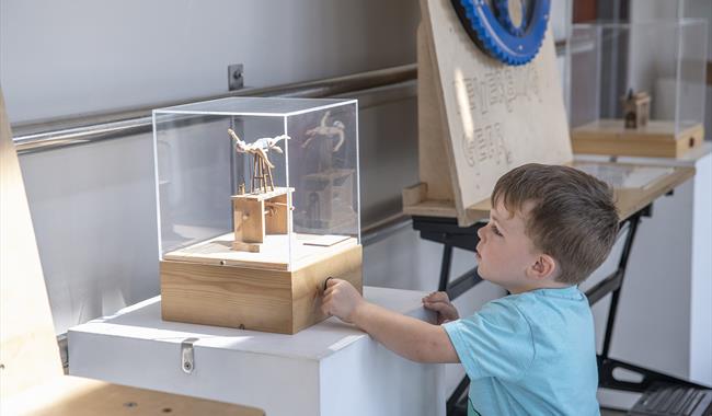 Child playing with exhibition