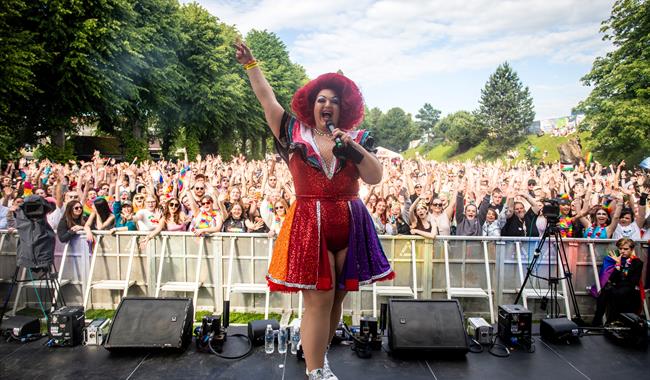 Photo of Delilah Tickles in front of the crowds at the Pride Canterbury main stage.