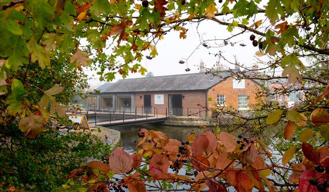 Whitchurch Silk Mill's Cafe and Shop Building surrounded by autumnal leaves