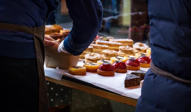 a selection of pastries being set up on a stand