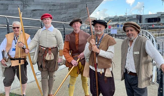 Archers gathered outside The Mary Rose in Tudor wear.