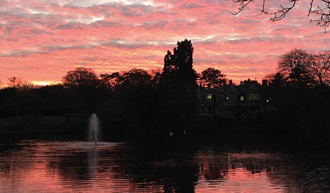A romantic pink and red sky above Bletchley Park's Mansion