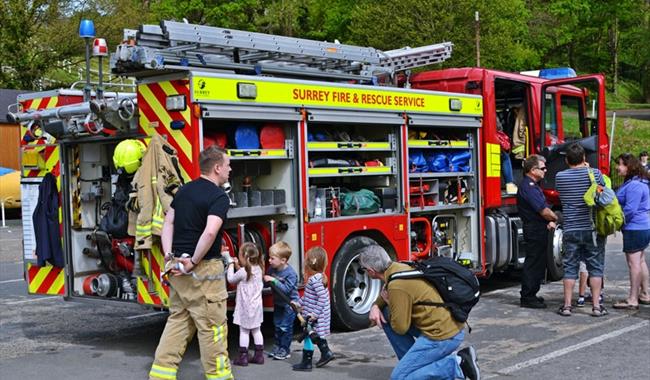 Visitors looking around a fire engine at Brooklands Museum in Surrey during their emergency services day