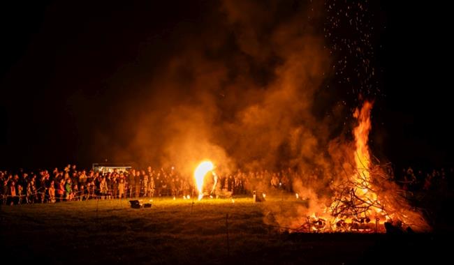 Fire Performer in front of a bonfire
