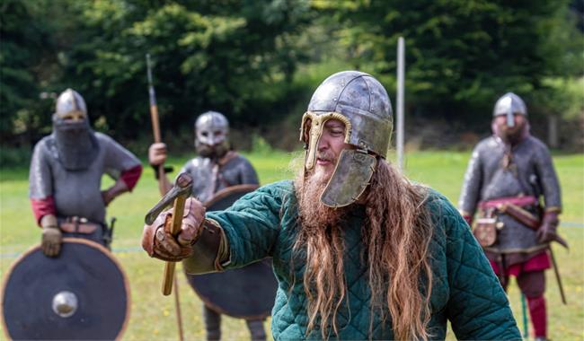 man in viking outfit holding sword