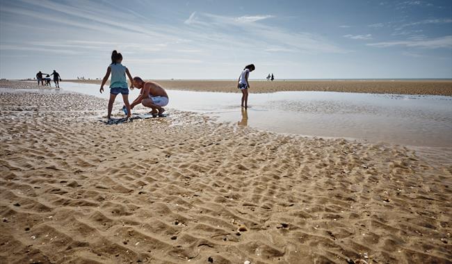 Children playing at low tide on Camber Sands
