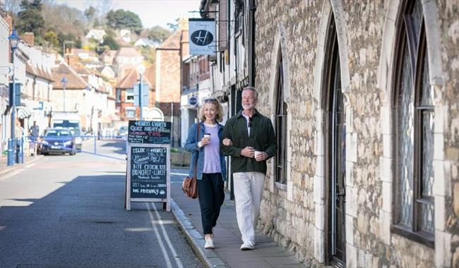 Couple walking along Hythe High Street in Kent