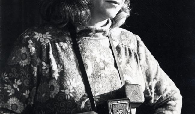 Black and white photograph showing a female photographer with a Rolleiflex camera