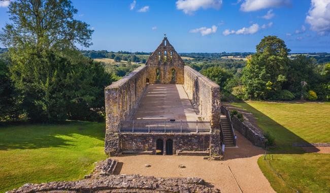 View of Battle Abbey in 1066 Country, with historic stone ruins overlooking the surrounding countryside.
